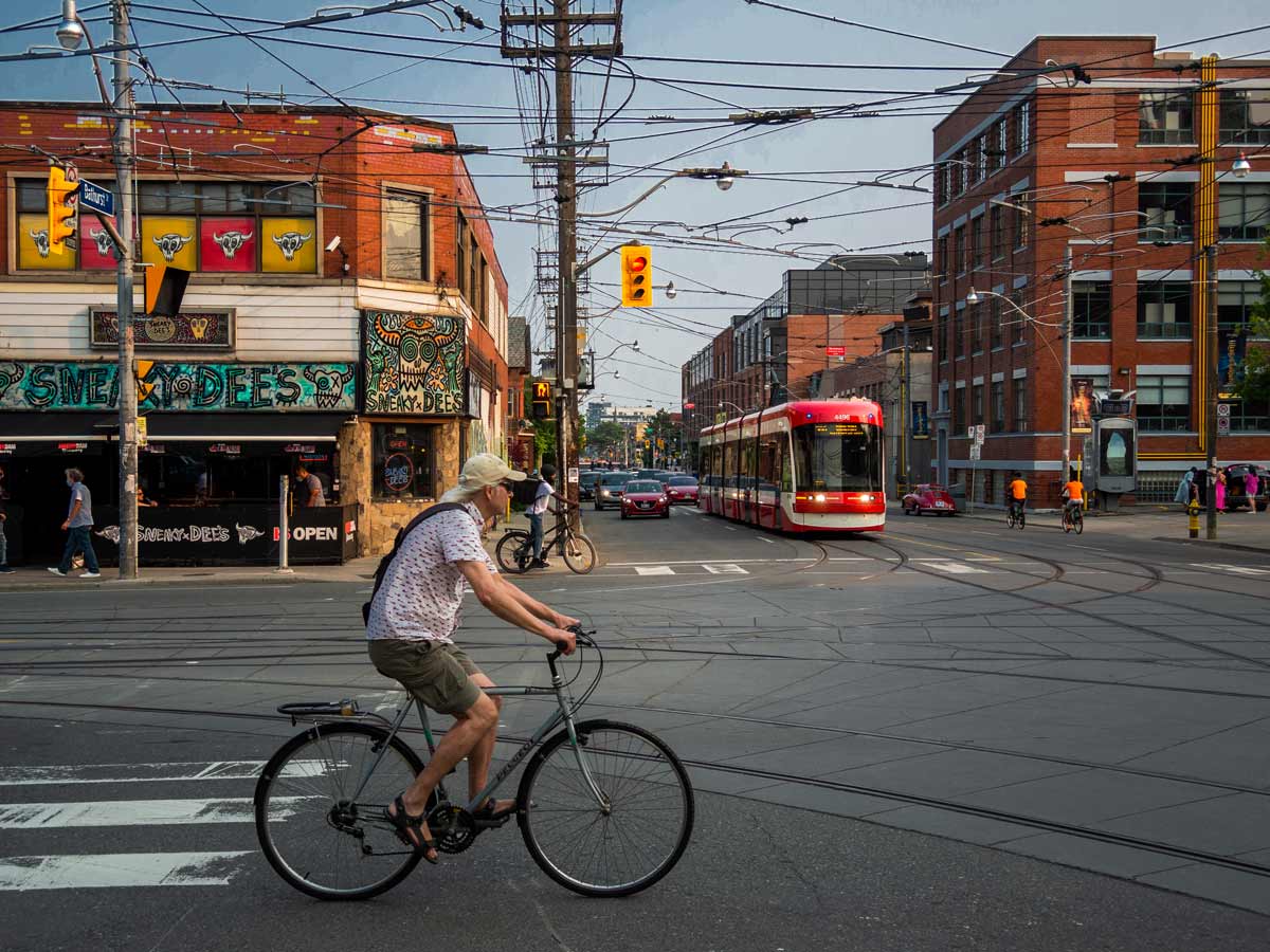 College St. streetcar and biker Toronto by @mikesimpson.ms